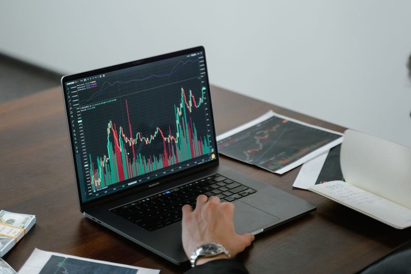 Laptop displaying financial charts and market data